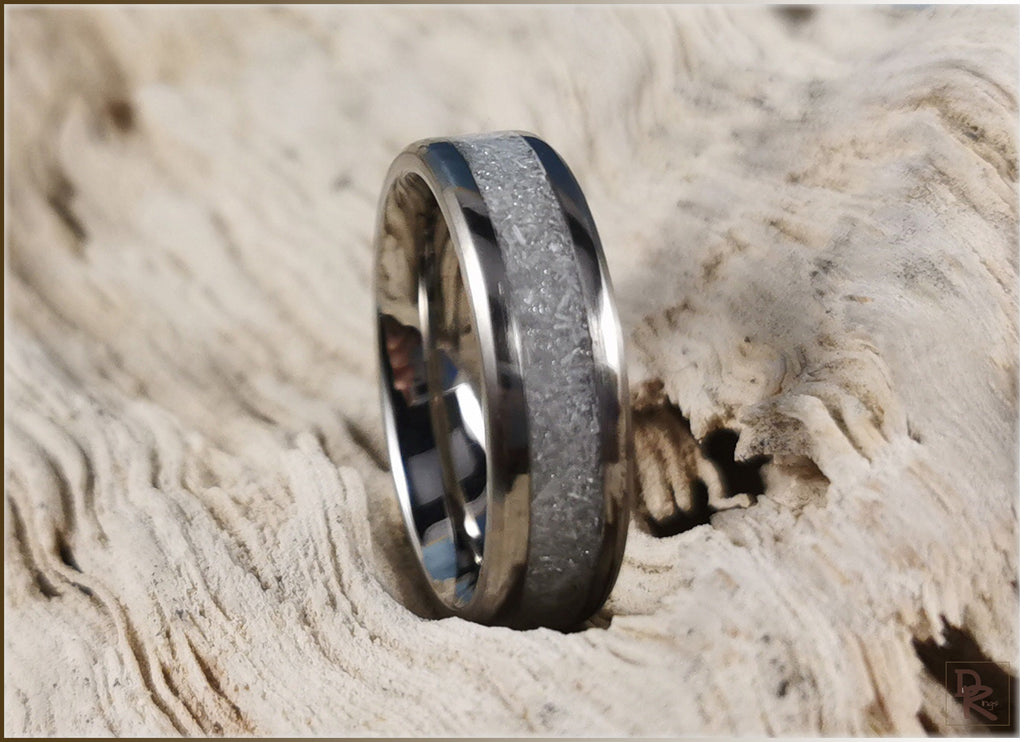 DR Rings titanium ring with selenite inlay on natural wood background showcasing sleek and modern design