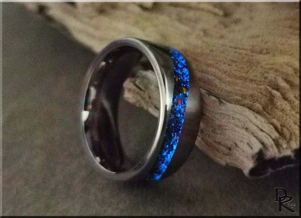 DR Rings titanium smart ring with glowing blue inlay on a wooden surface