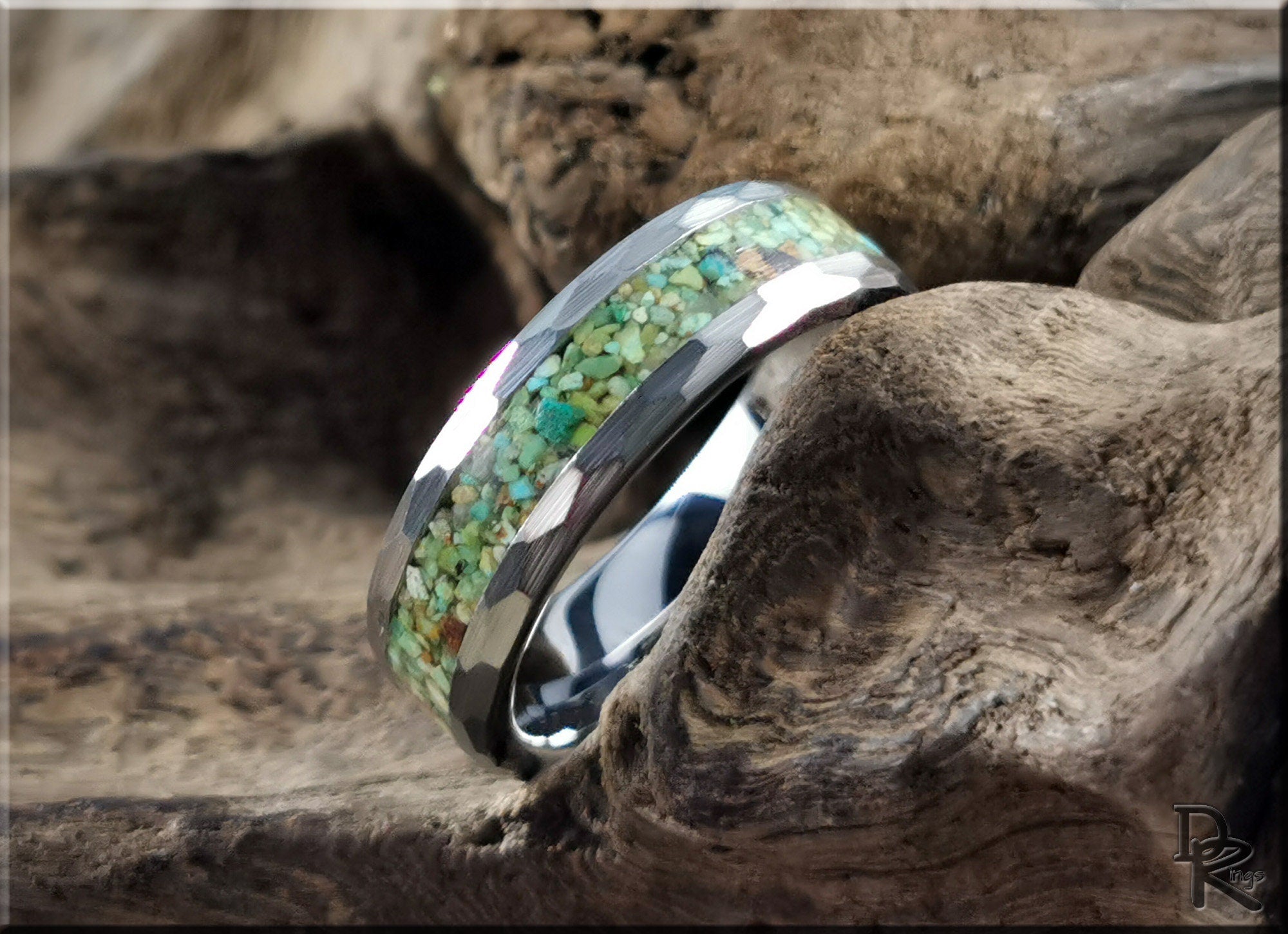 DR Rings tungsten as a ring with green stone inlay on textured wood background