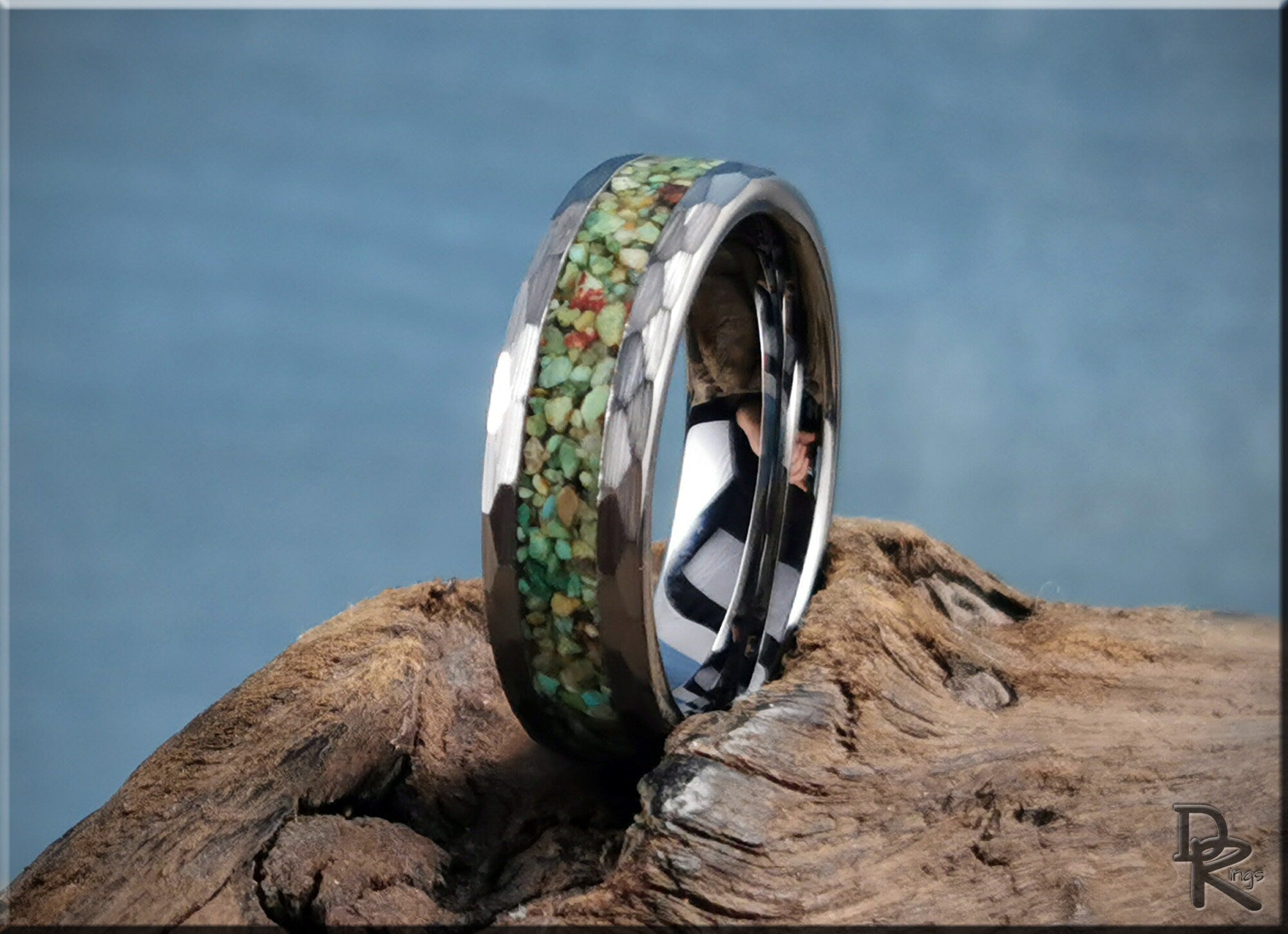 DR Rings tungsten as a ring with green and brown stone inlay and polished beveled edges on wood