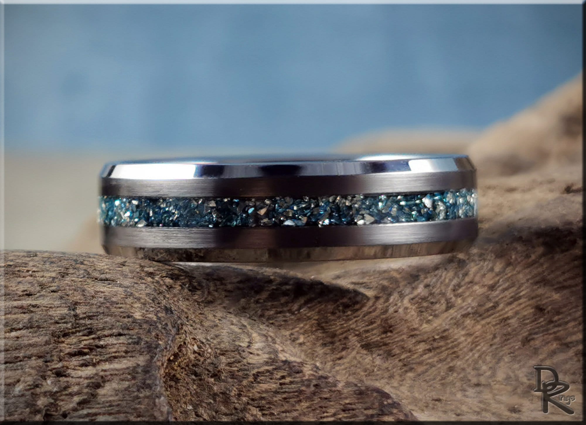 DR Rings tungsten as a ring with blue crushed stone inlay and polished edges on wood background