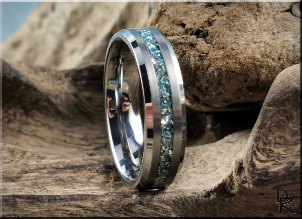 DR Rings tungsten as a ring with blue crushed stone inlay on a textured wooden background