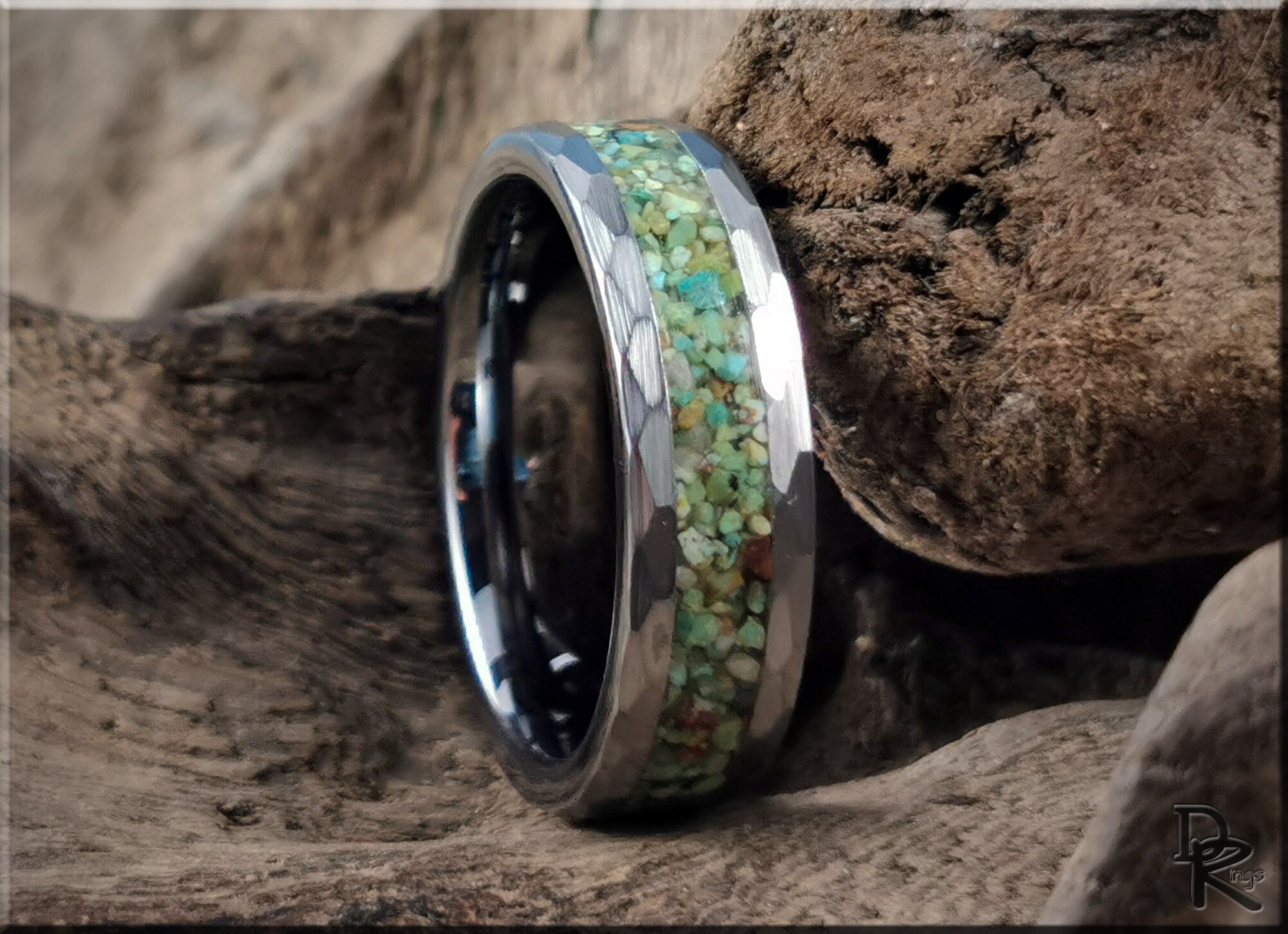 DR Rings tungsten as a ring with a hammered silver finish and green stone inlay on rustic wood background