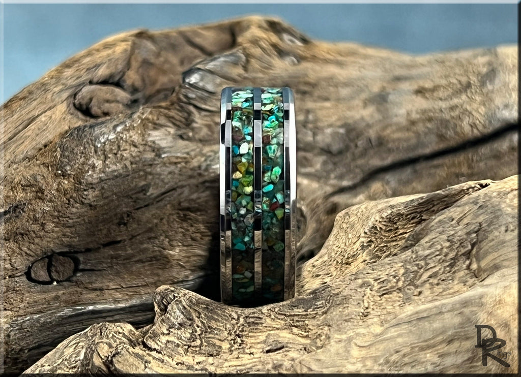 Tungsten carbide ring with two inlays featuring multicolored stone design by DR Rings on wood background