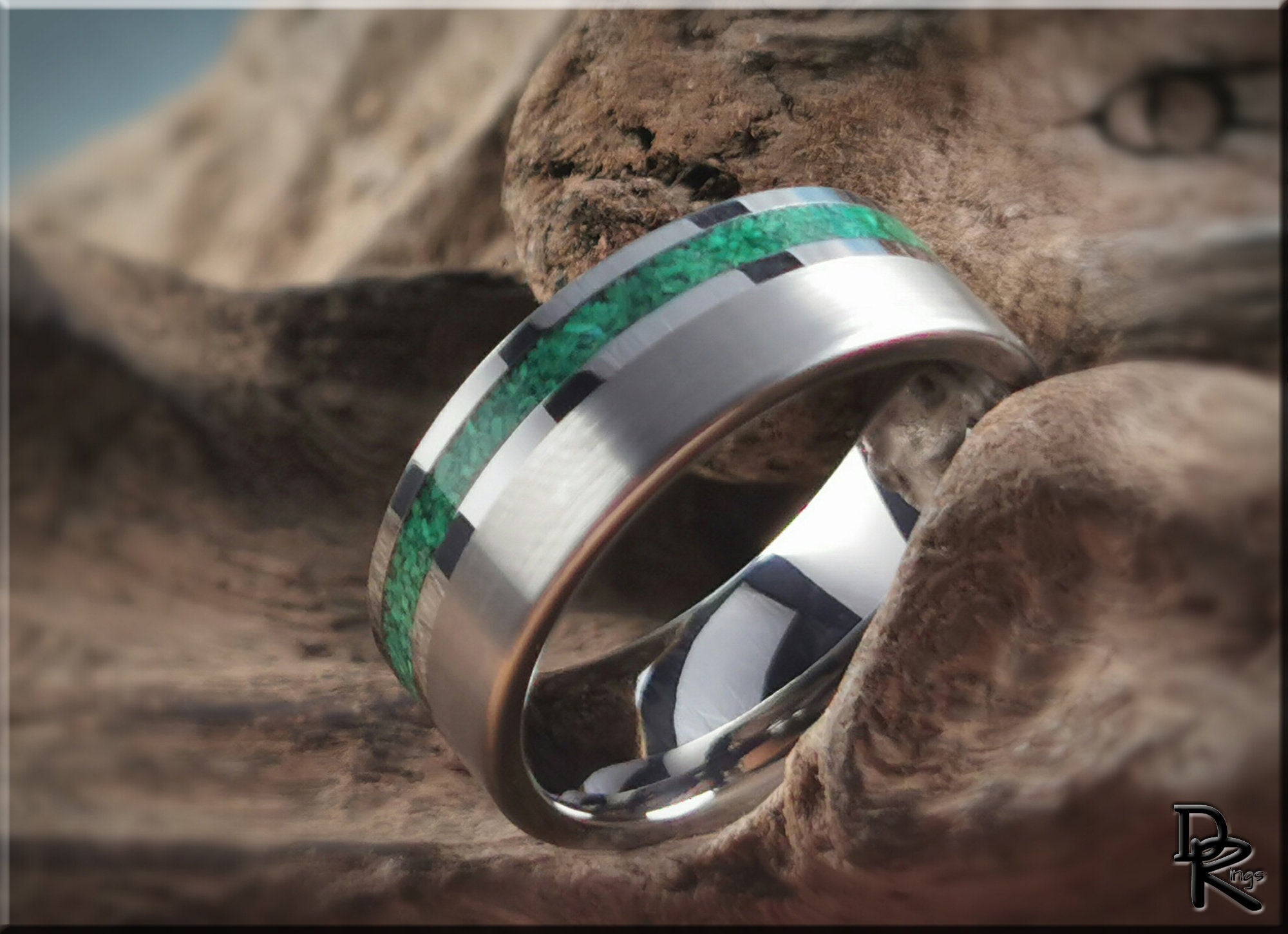 DR Rings tungsten ring carbide with green inlay and polished silver band on rustic wood background