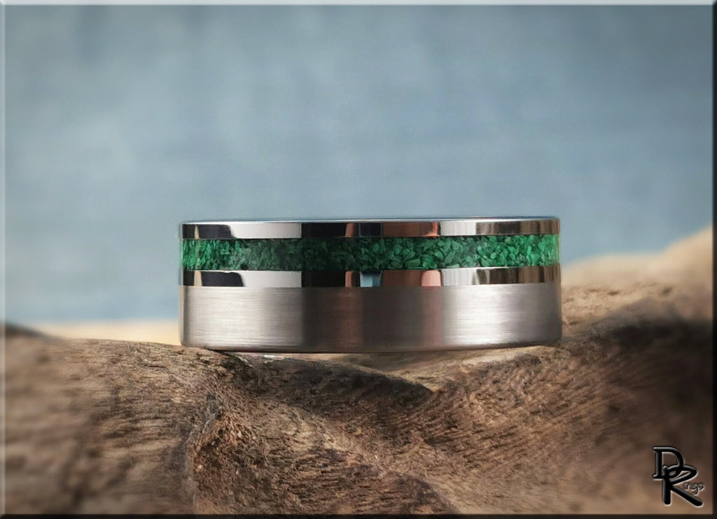 DR Rings tungsten ring carbide with green inlay and polished silver edges on rustic wood background