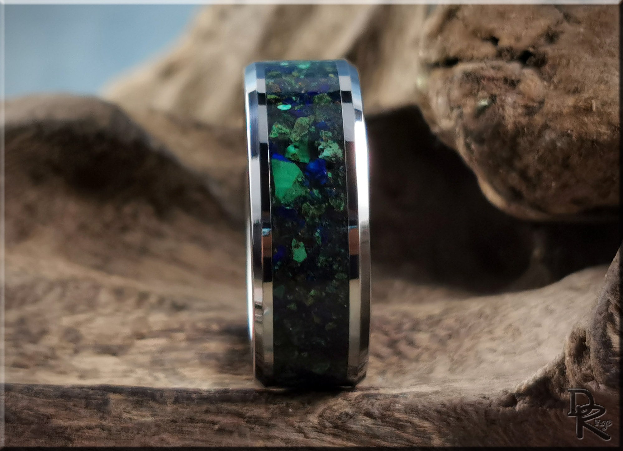DR Rings tungsten ring carbide with green and blue stone inlay on rustic wooden background