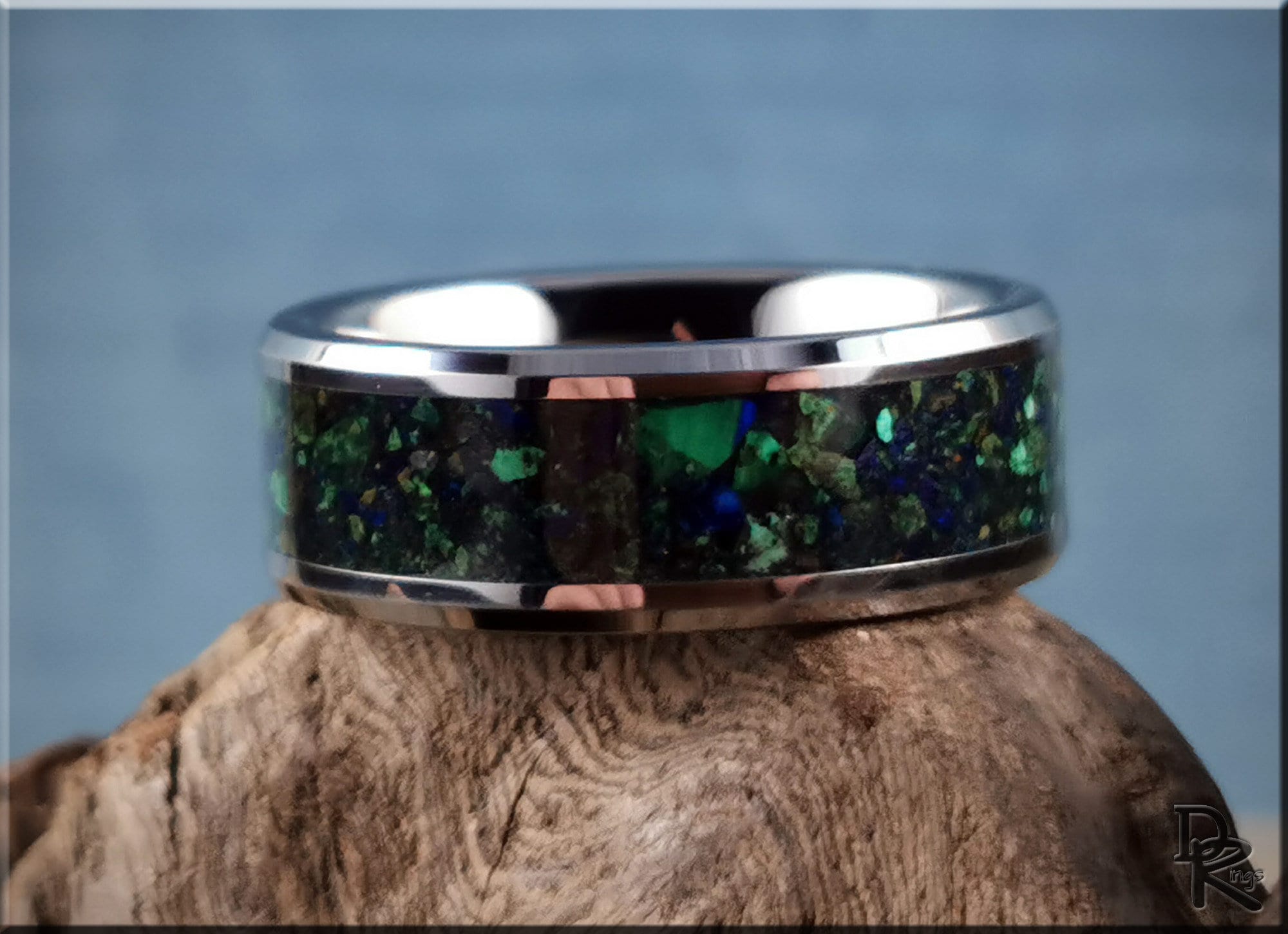 DR Rings tungsten ring carbide with green opal inlay and polished silver edges on wood background
