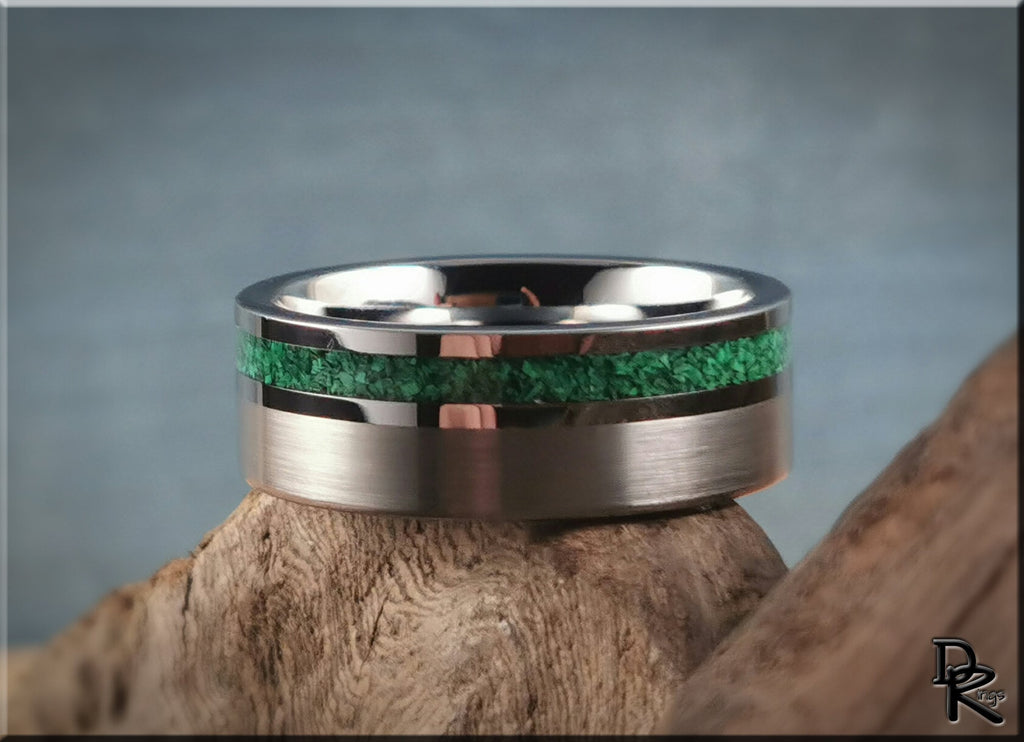 DR Rings tungsten ring carbide with green inlay on a wooden surface background
