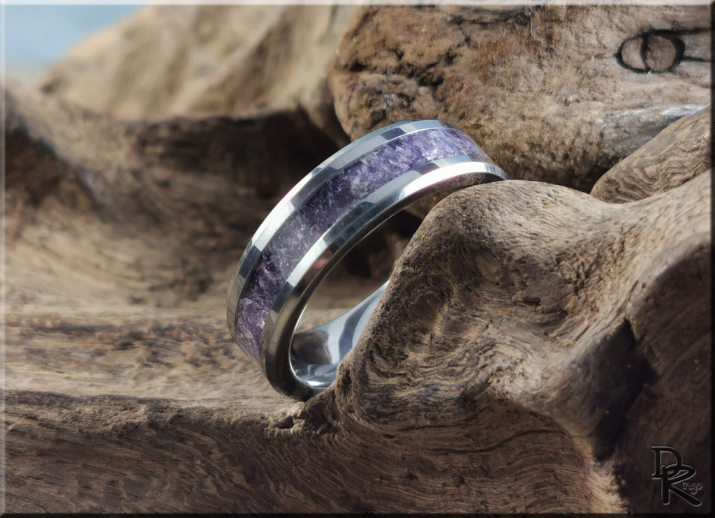 DR Rings tungsten ring with amethyst inlay resting on textured natural wood background