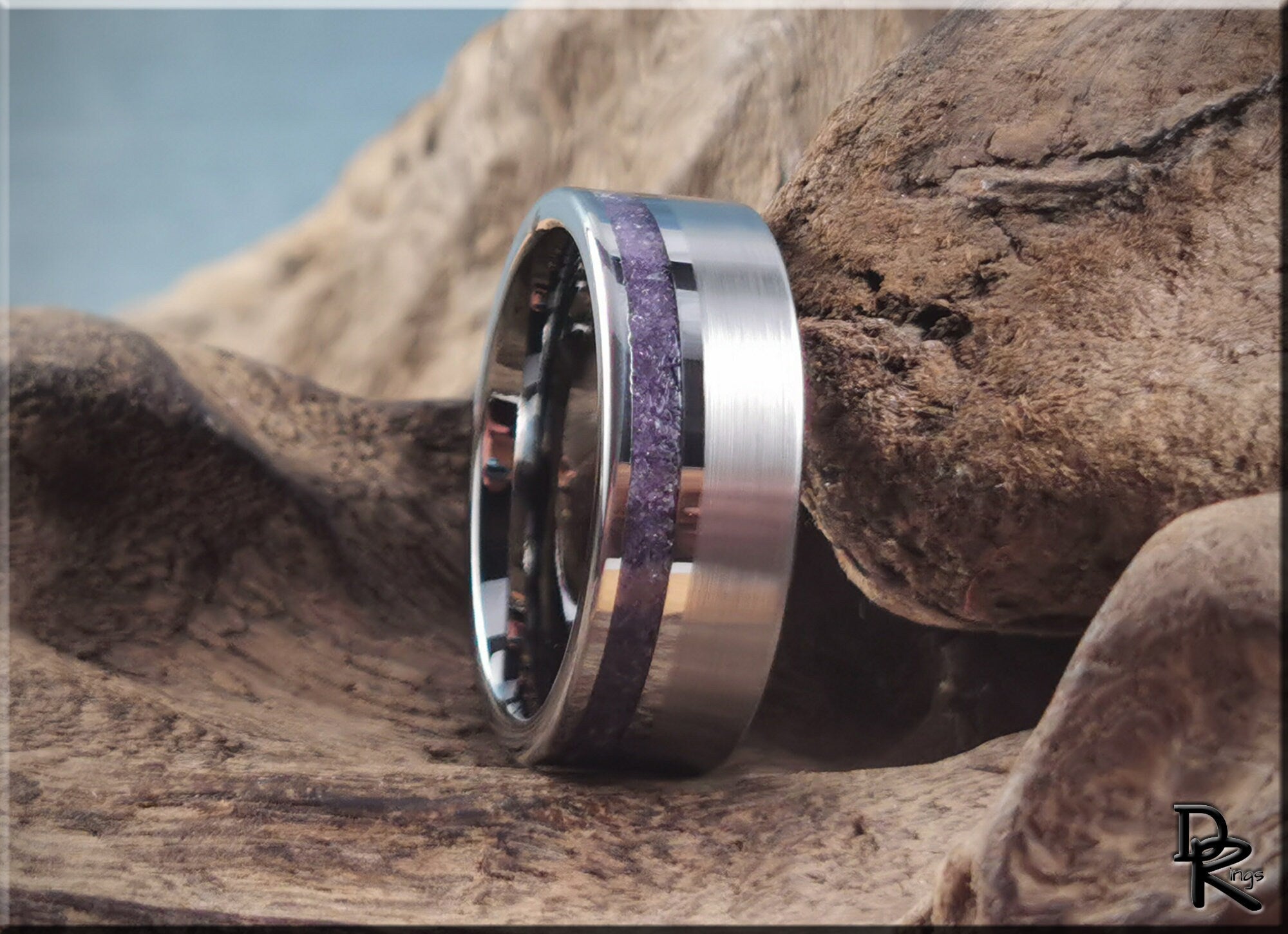 DR Rings tungsten ring with amethyst band inset displayed on natural wood background