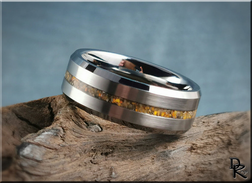 Tungsten ring with jasper inlay featuring a polished silver finish on natural wood background