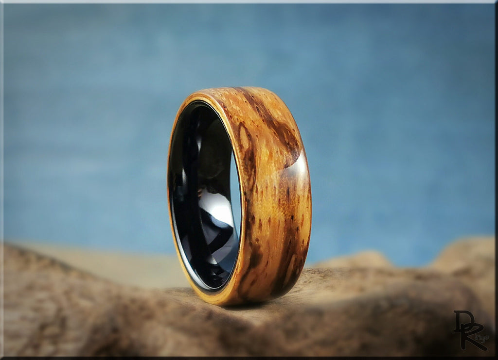 Wood ring on ceramic core by DR Rings with polished natural wood grain and black ceramic interior