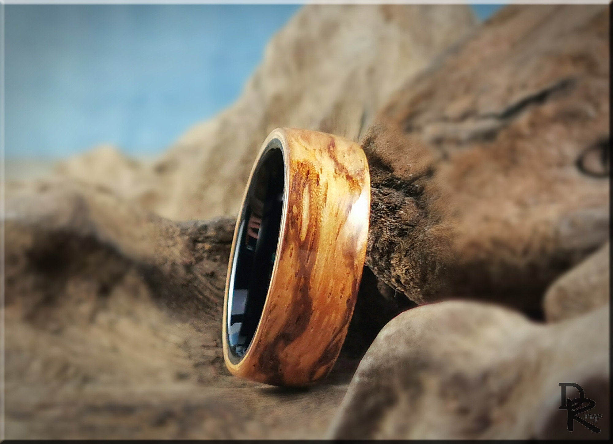 DR Rings wood ring on ceramic core with natural wood grain texture on display
