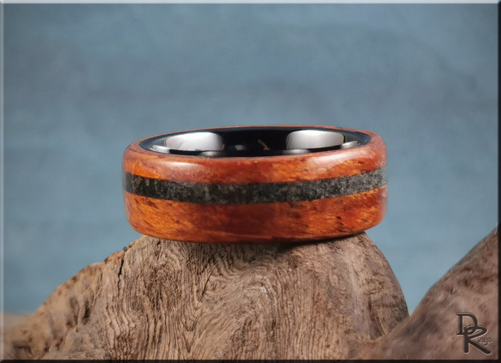 DR Rings wood ring with inlay featuring polished wood and dark stone center band on natural wood background