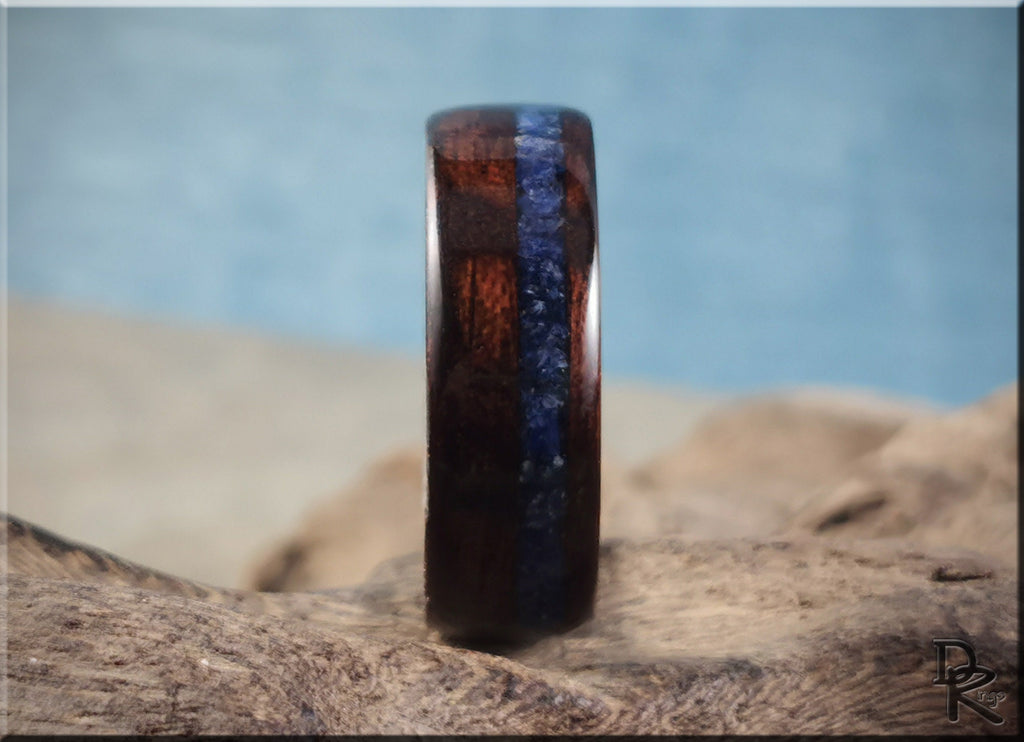 DR Rings wood ring with inlay featuring dark wood and a blue stone stripe on a natural background