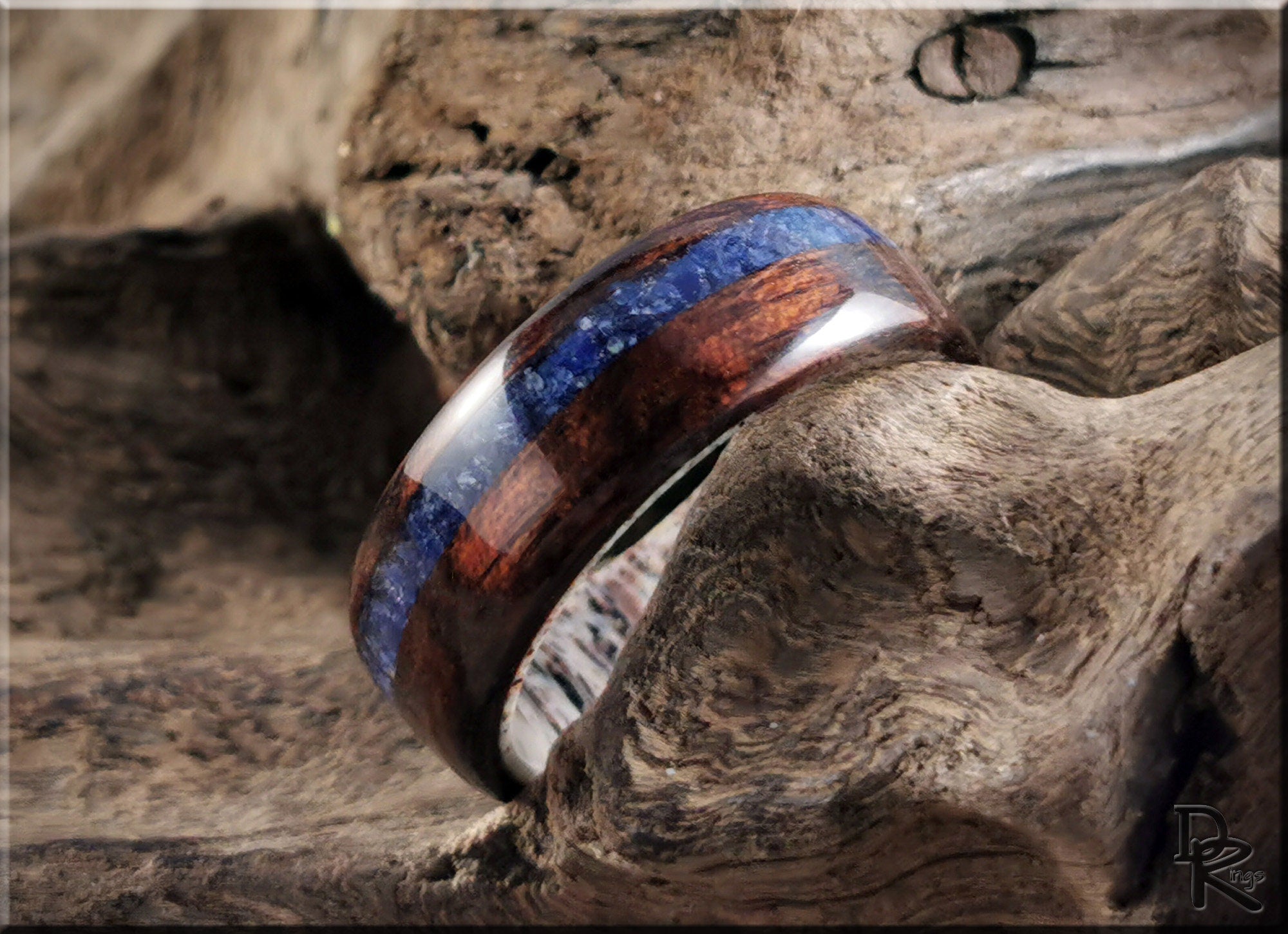 DR Rings wood ring with inlay featuring blue and brown accents on natural wood background
