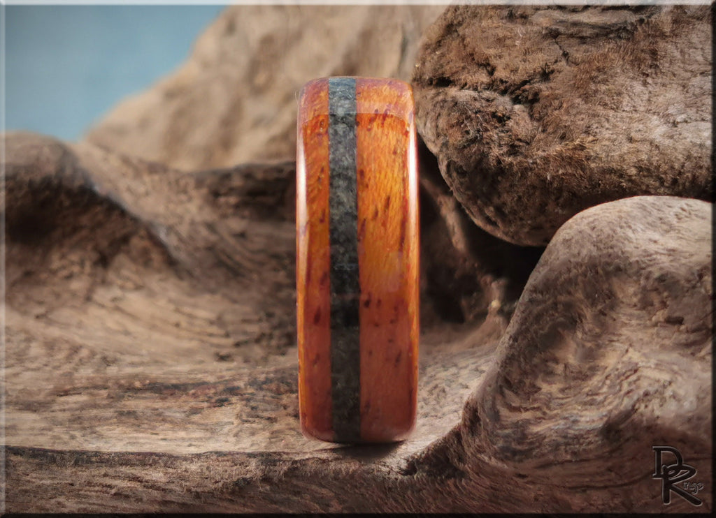 DR Rings wood ring with inlay featuring a polished brown and black design on natural wood background