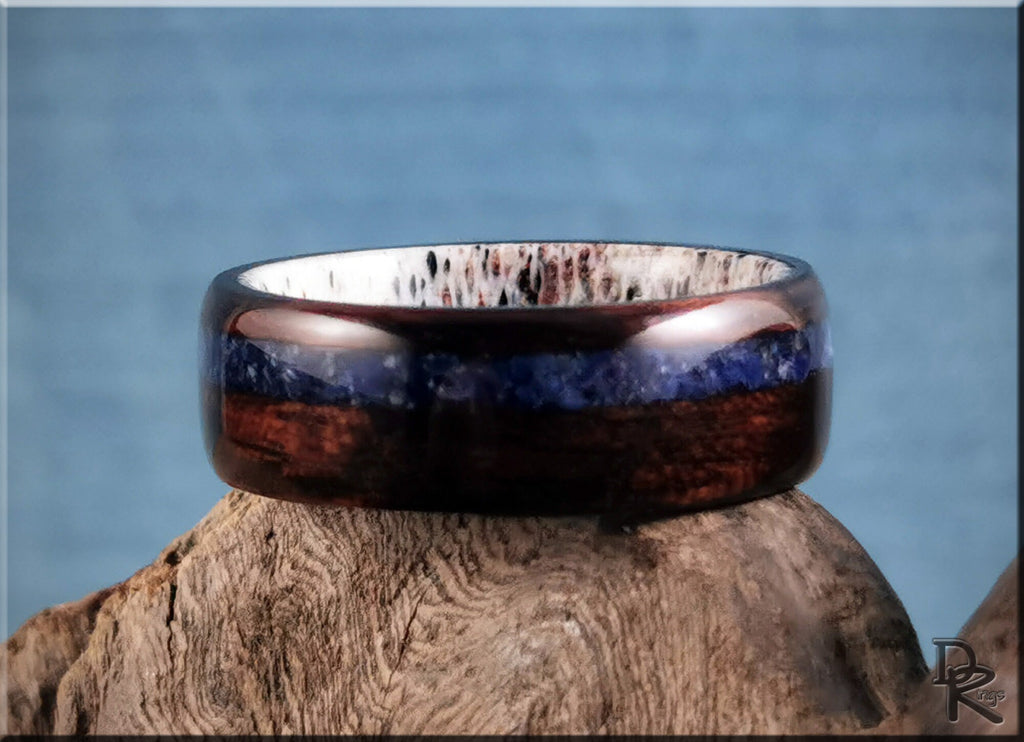DR Rings wood ring with inlay featuring dark wood and blue stone details on a rustic background