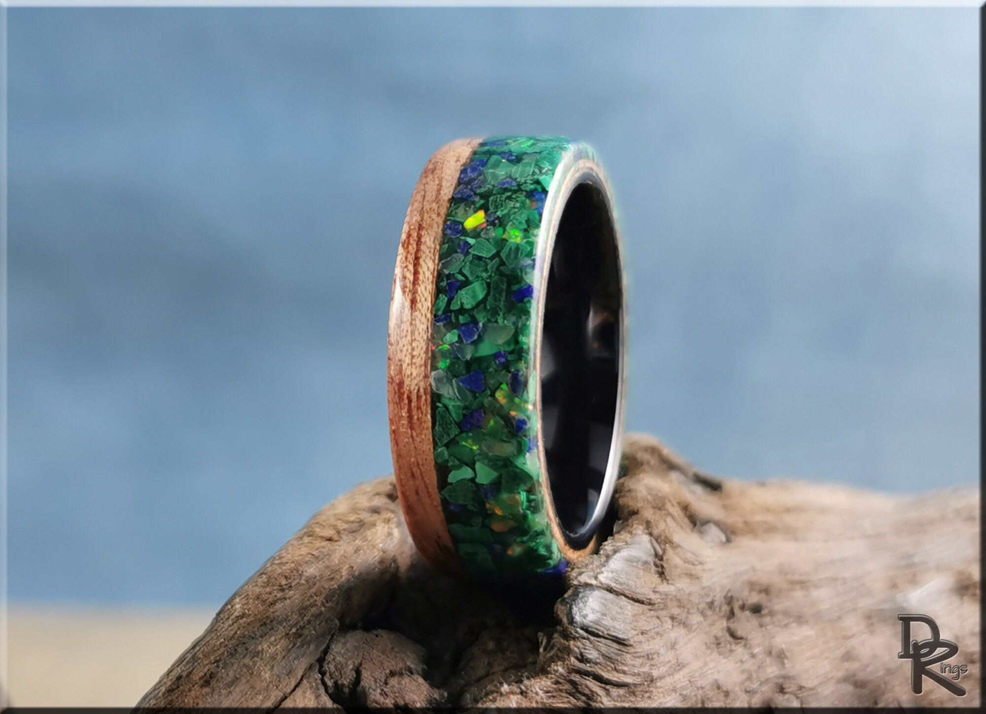 Wood ring with malachite inlay featuring green and blue tones by DR Rings on rustic wood