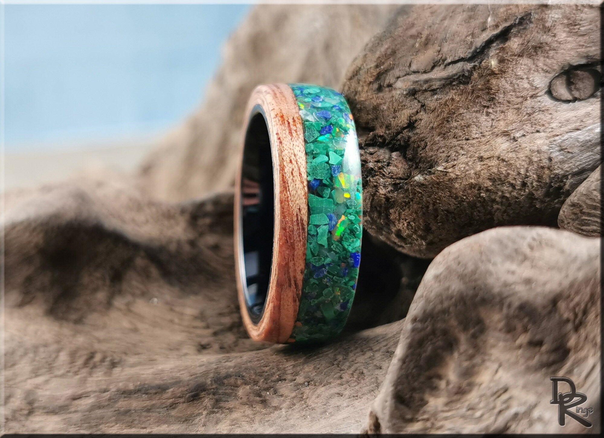 DR Rings wood ring with malachite inlay featuring vibrant green and blue tones on natural wood background