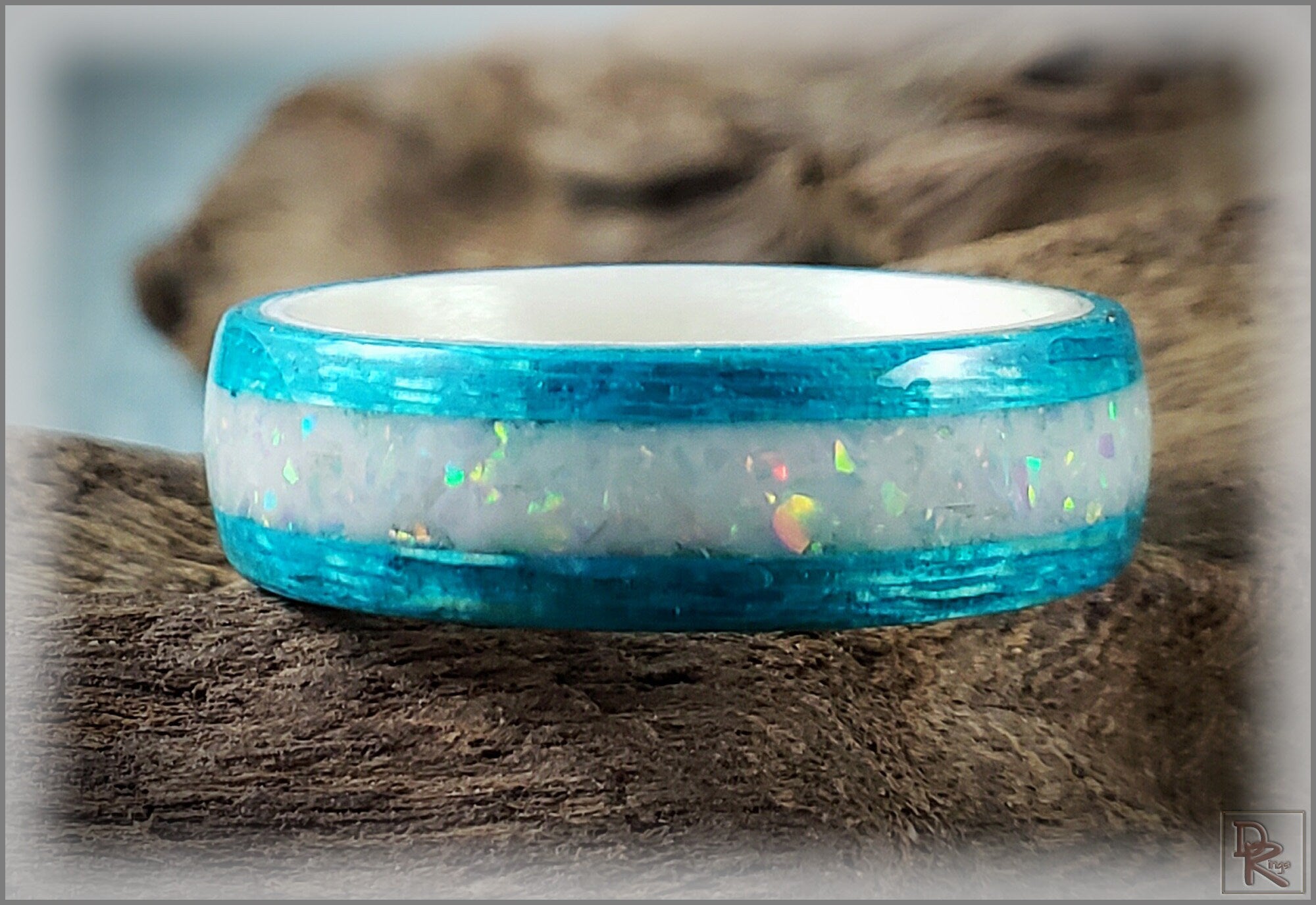 DR Rings wood ring with opal inlay featuring vibrant blue edges and iridescent white center