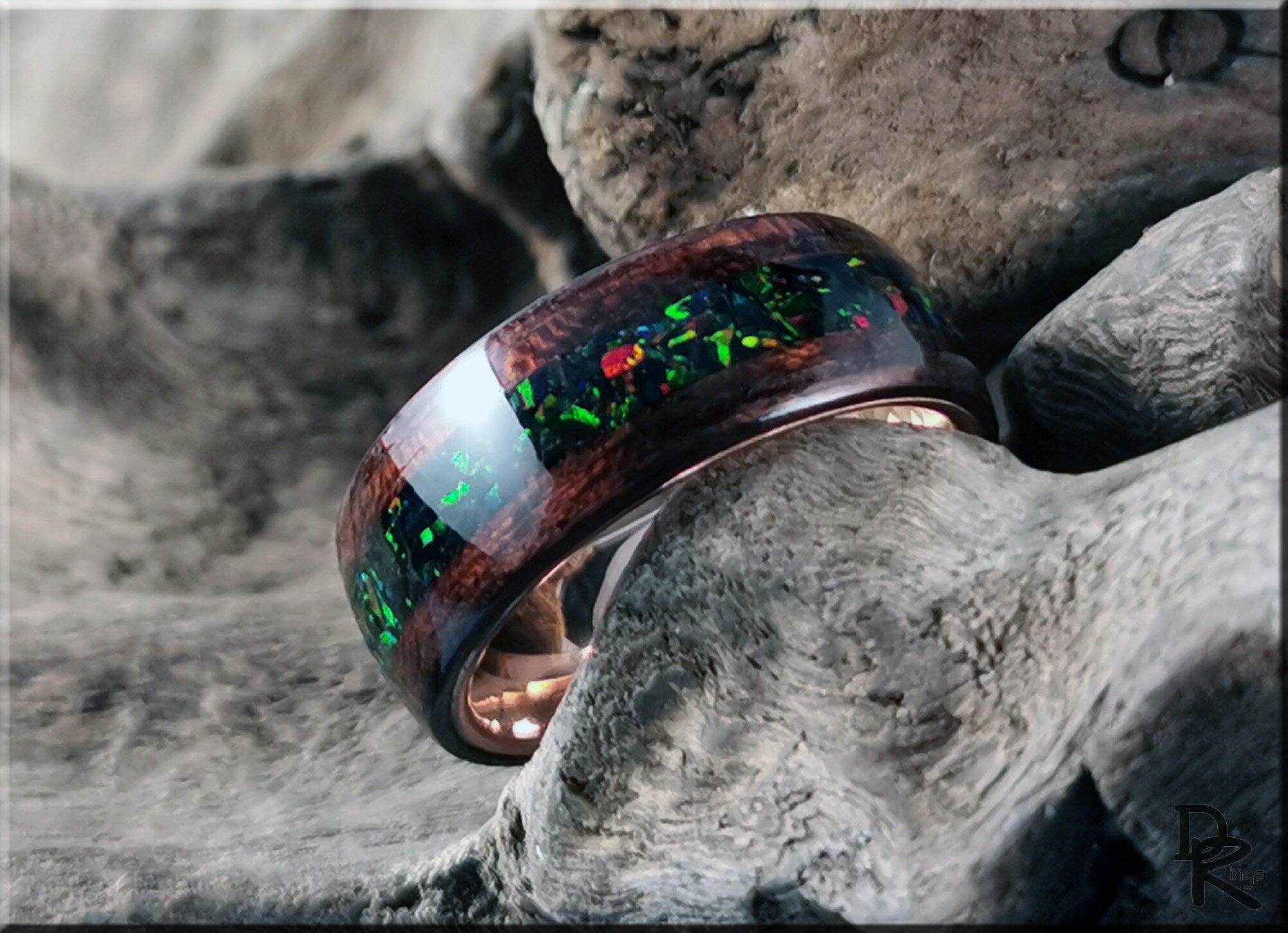DR Rings elegant wood ring with opal inlay featuring vibrant green and red colors on rustic background
