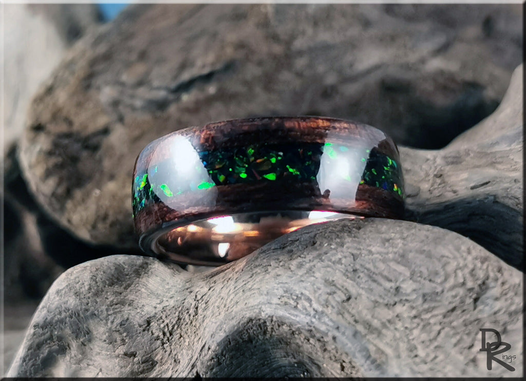 DR Rings wood ring with opal inlay featuring dark wood and green opal accents on natural textured background