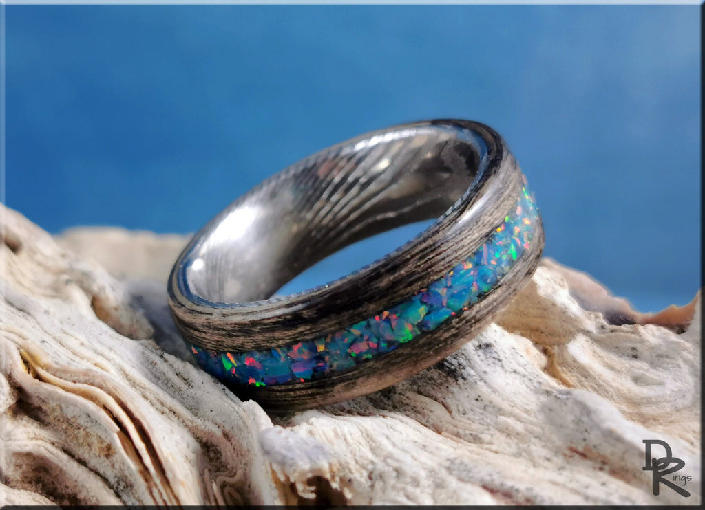 Wood ring with opal inlay featuring vibrant blue and green opal stones set in dark wood band