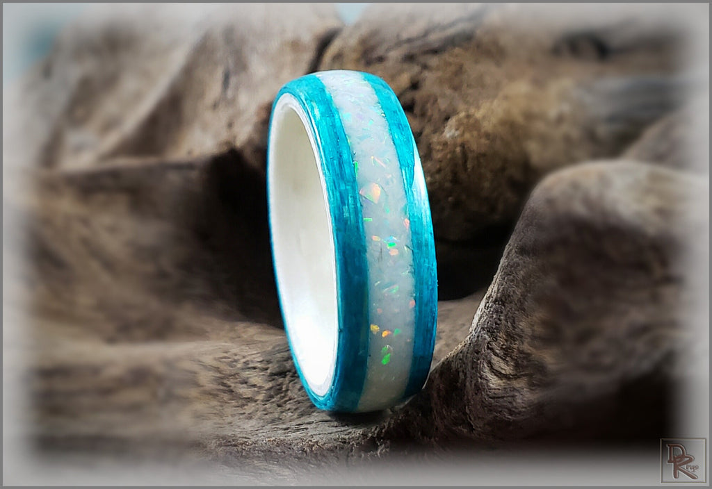 Wood ring with opal inlay featuring vibrant blue edges and shimmering white opal center by DR Rings