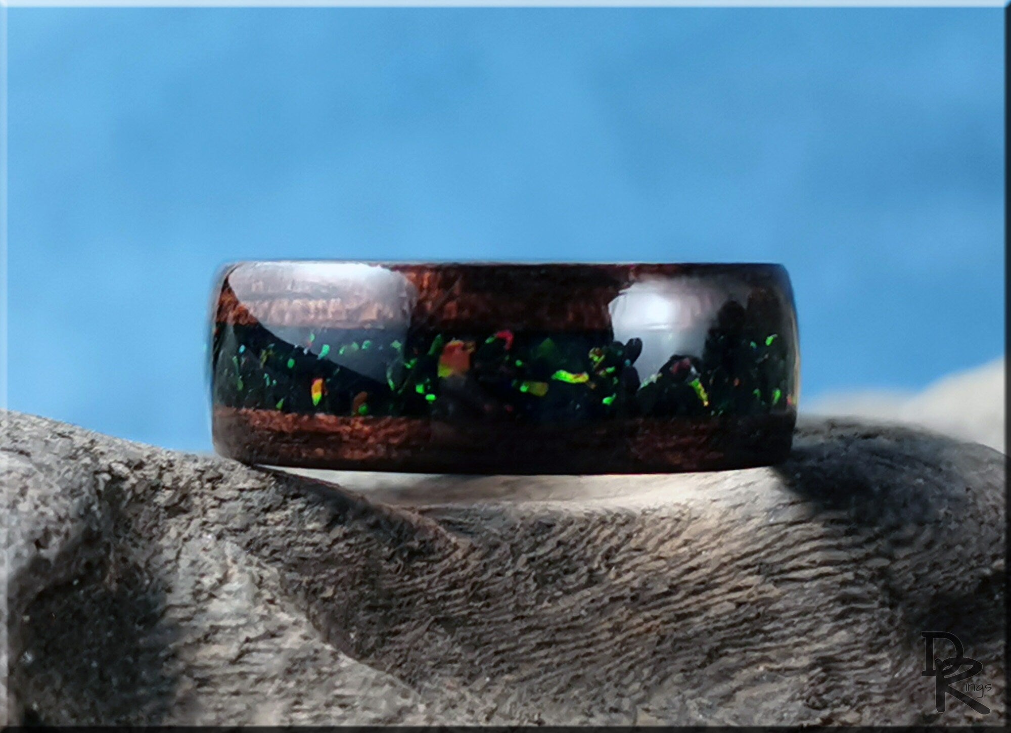 DR Rings wood ring with opal inlay featuring dark wood and vibrant green opal accents