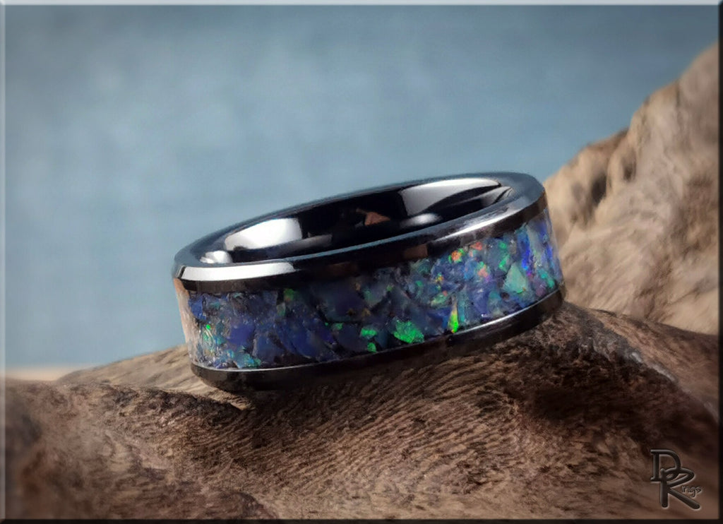 Black ceramic ring with opal inlay featuring vibrant blue and green hues by DR Rings