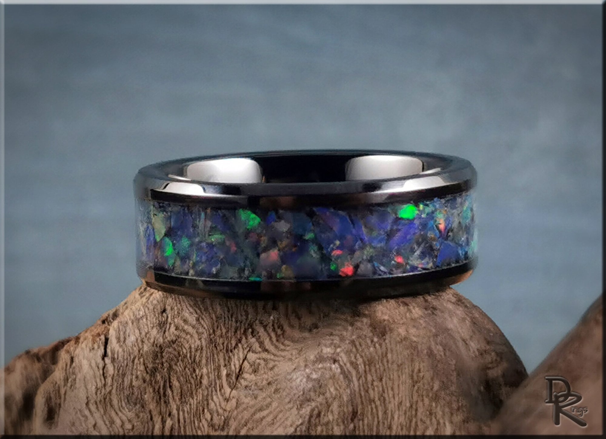 DR Rings black ceramic ring with opal inlay featuring vibrant blue and green tones