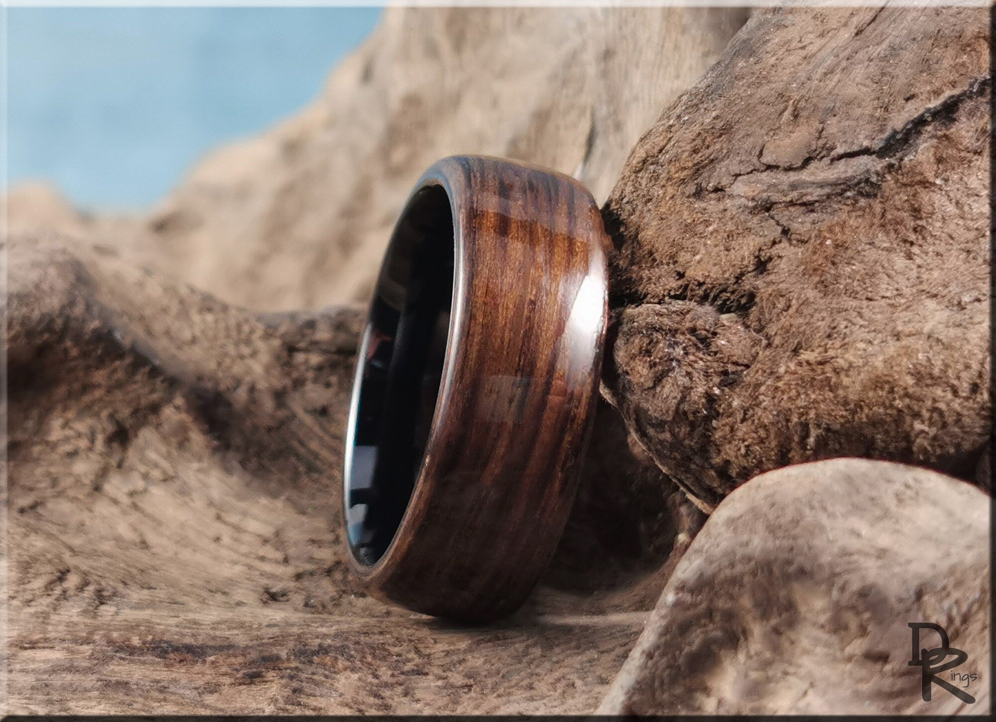 Bog oak ring on ceramic surface showcasing natural wood grain and polished finish by DR Rings