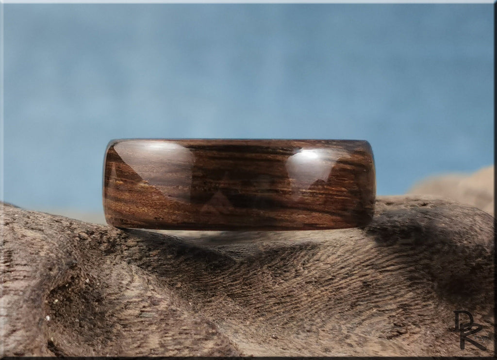 Bog oak ring on ceramic surface with smooth polished dark wood grain by DR Rings