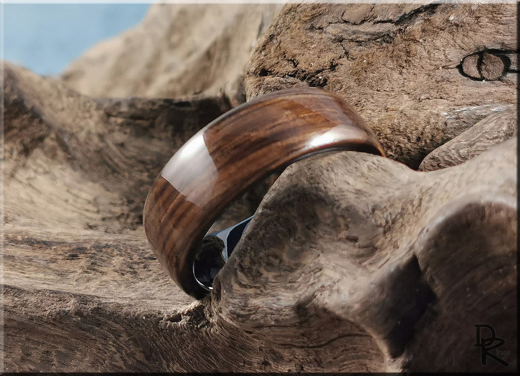 Bog oak ring on ceramic surface highlighting natural wood grain and smooth polished finish