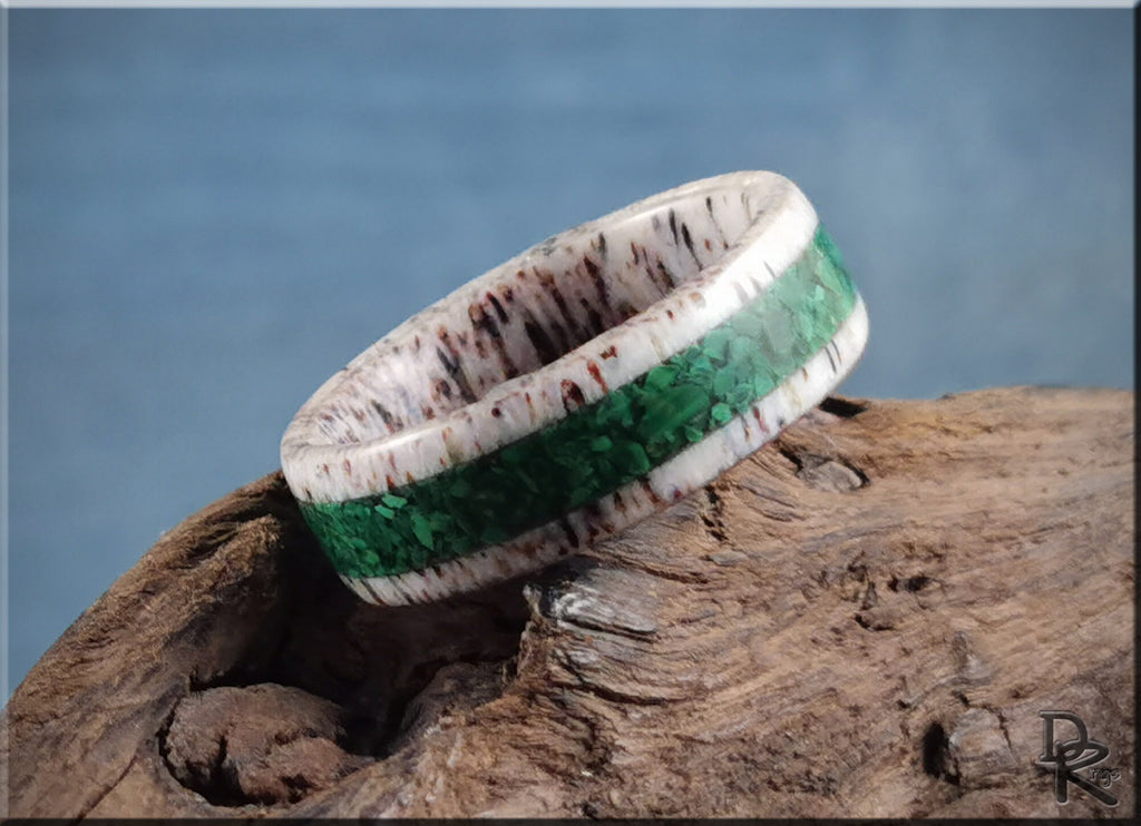 DR Rings antler ring with a green inlay design displayed on rustic wood background