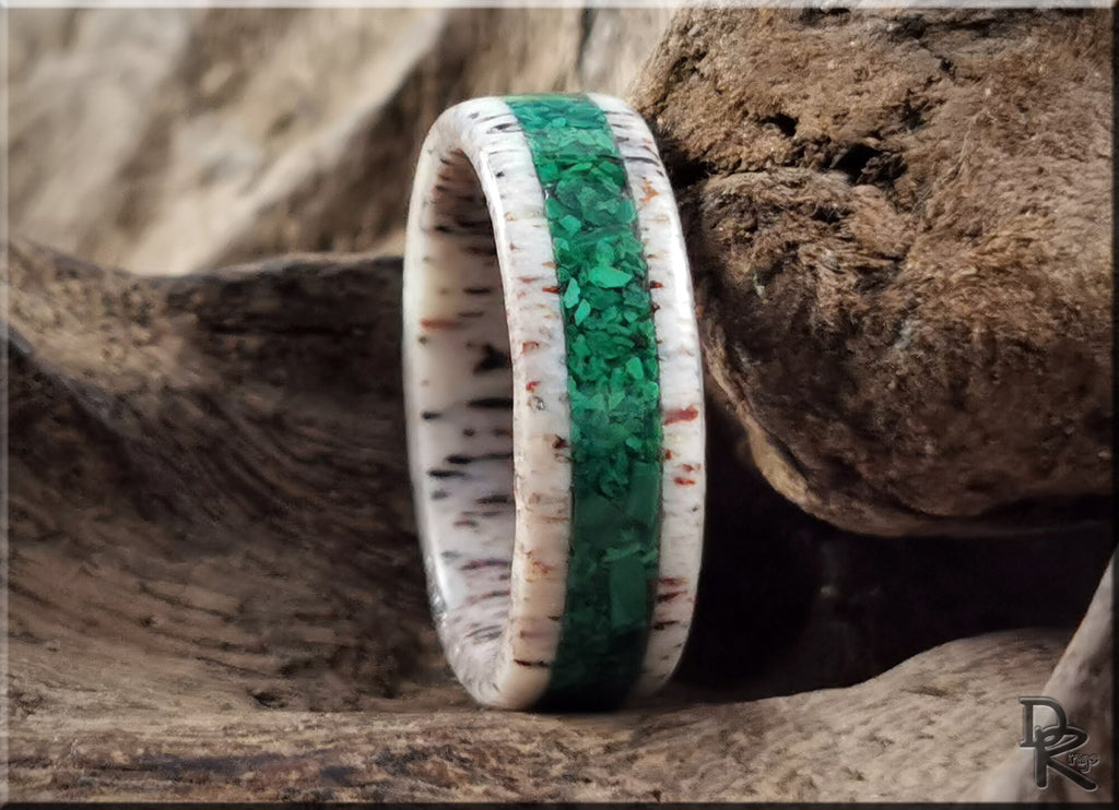 DR Rings antler ring with green inlay and natural textured design on rustic wood background