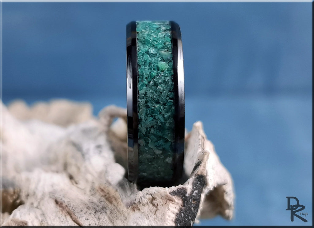 DR Rings ceramic ring with inlay featuring green stone center and black edges on natural background
