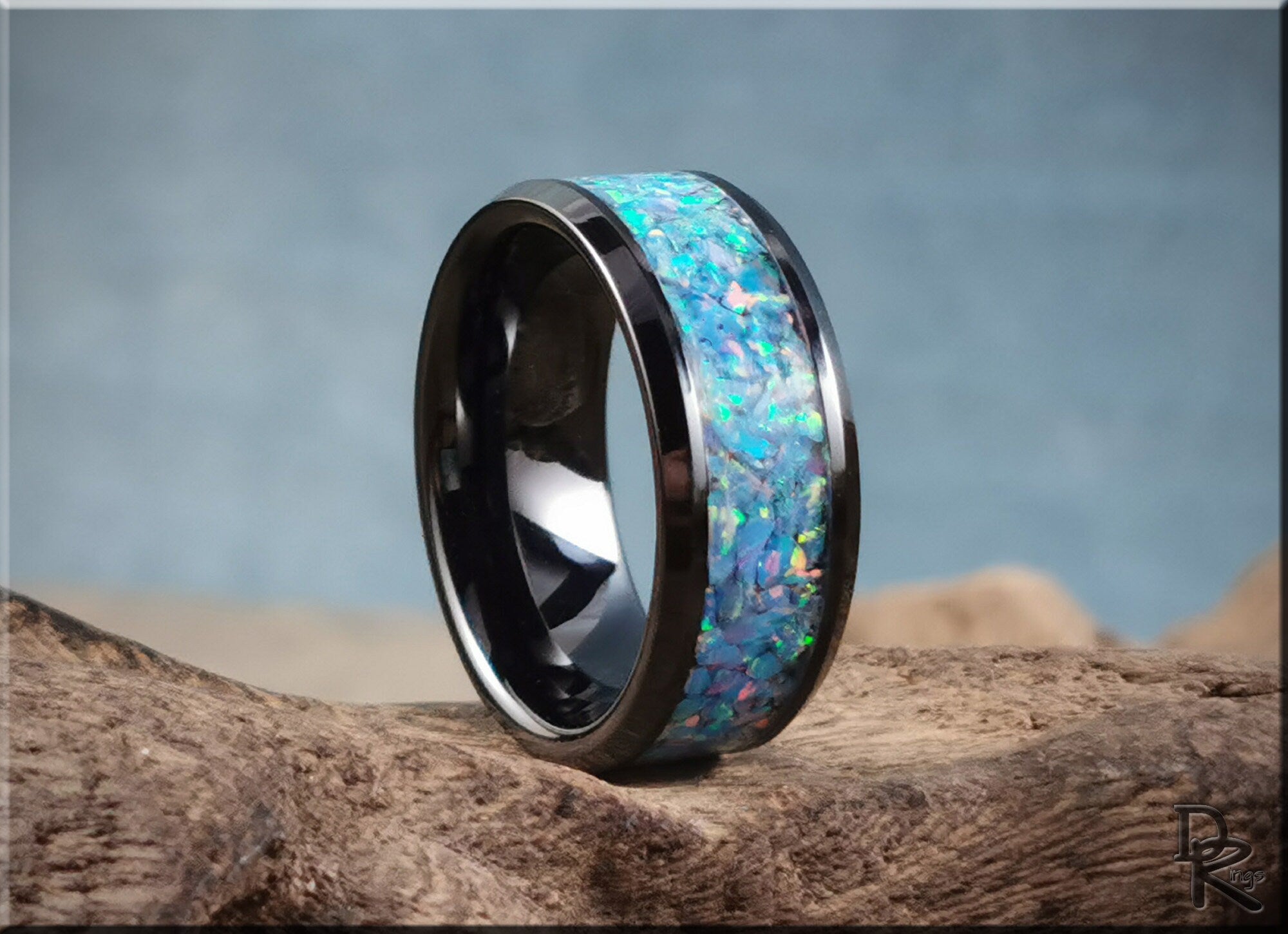 DR Rings ceramic ring with opal inlay featuring vibrant blue and green opal stones on black ceramic band