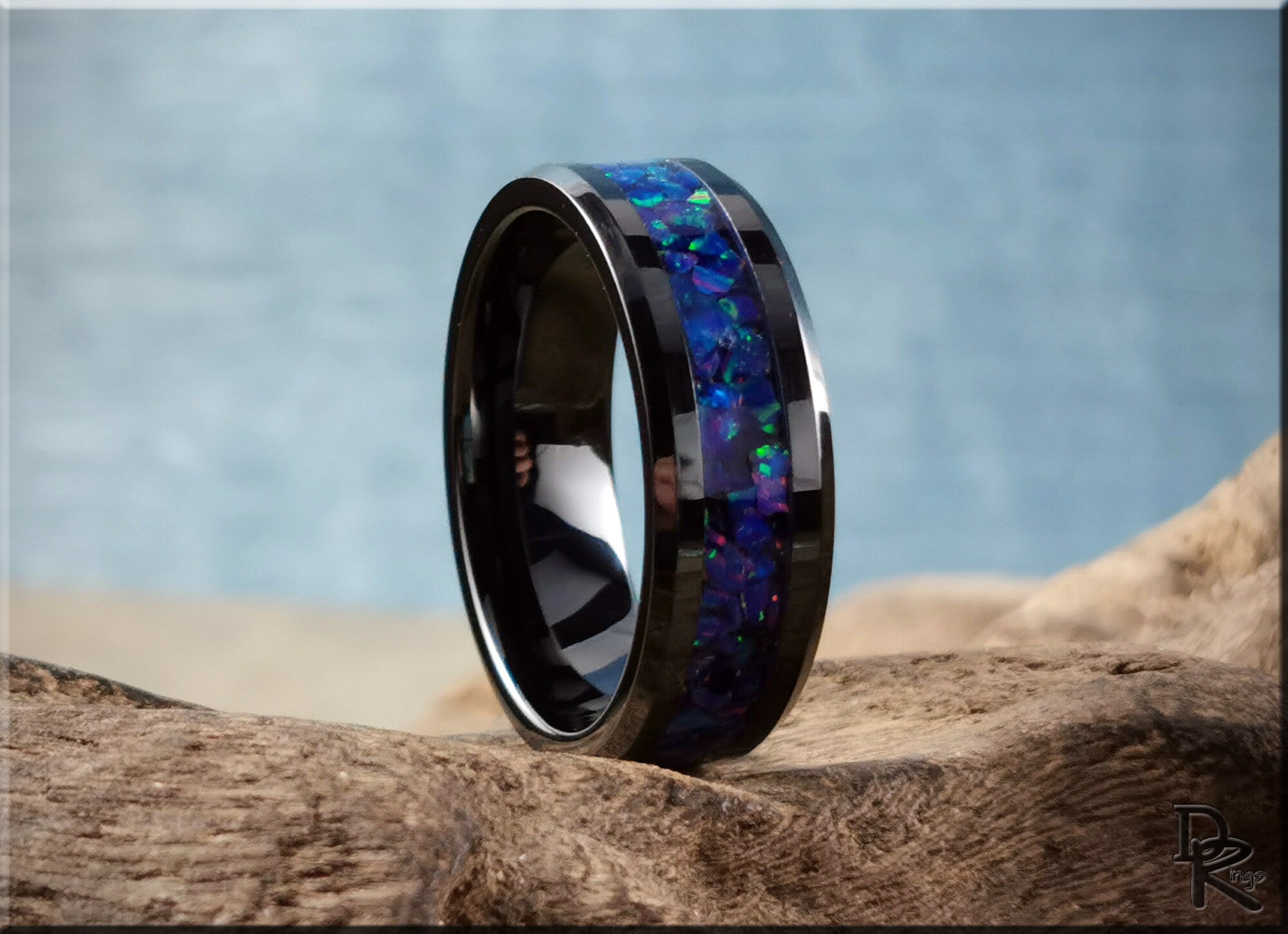 Black ceramic ring with opal inlay featuring vibrant blue and green colors from DR Rings
