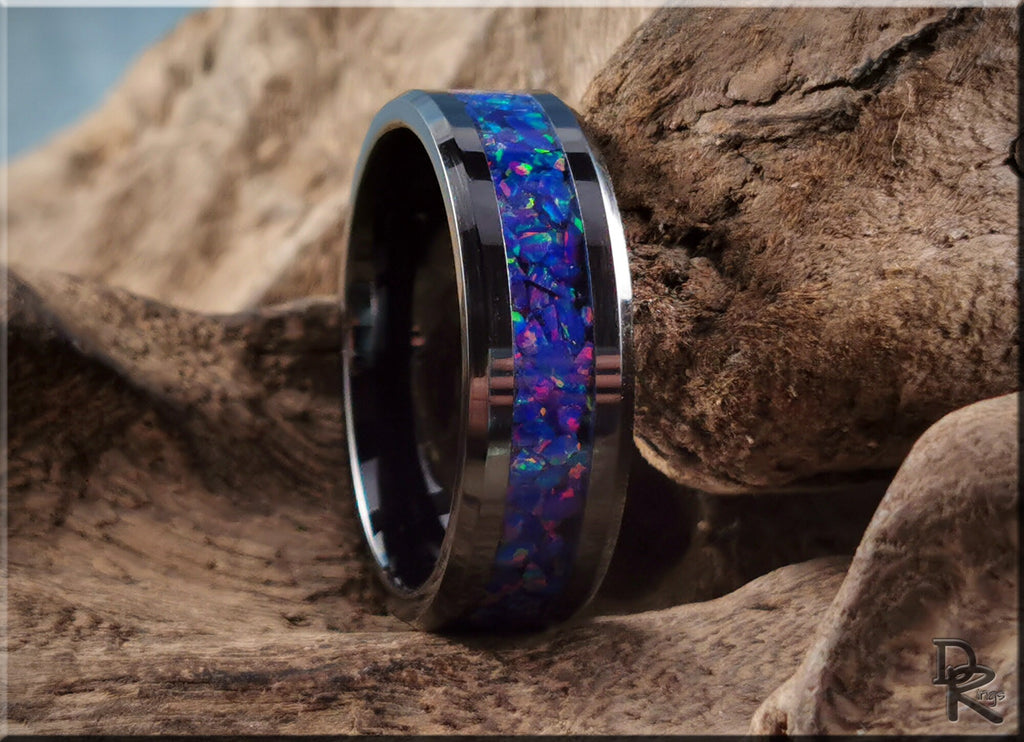 Ceramic ring with opal inlay featuring vibrant blue and purple colors by DR Rings on wood background
