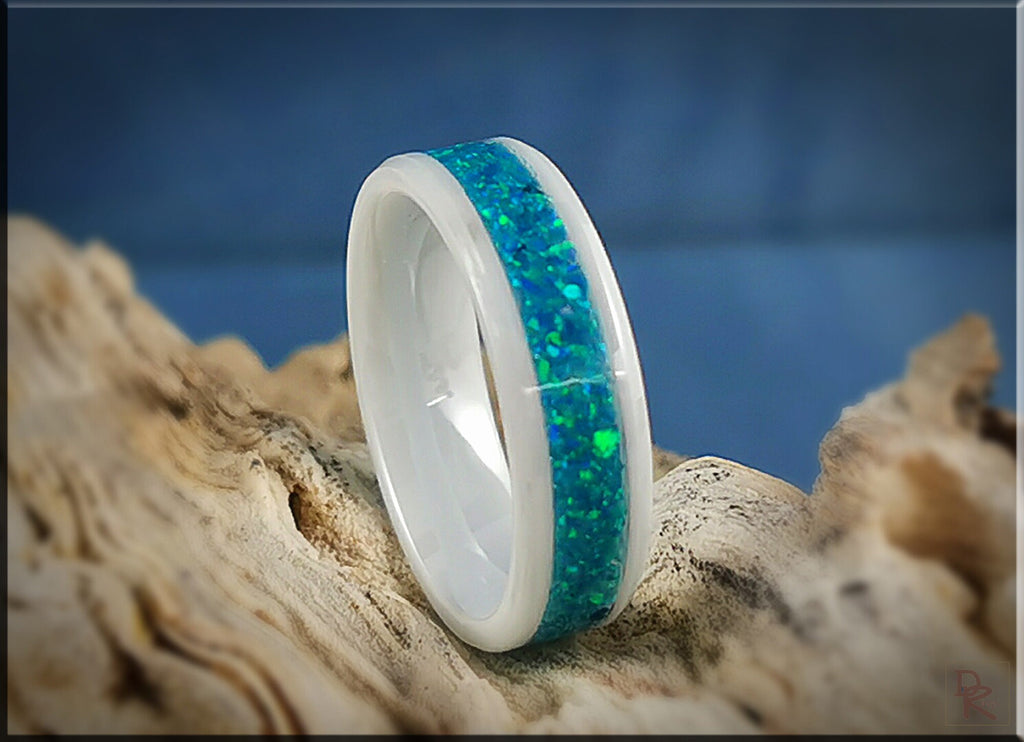 White ceramic ring with opal inlay featuring vibrant blue and green hues from DR Rings
