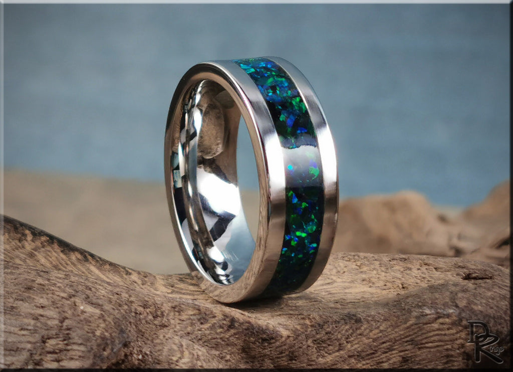 DR Rings cobalt chrome ring with opal inlay featuring vibrant blue and green hues on rustic wood