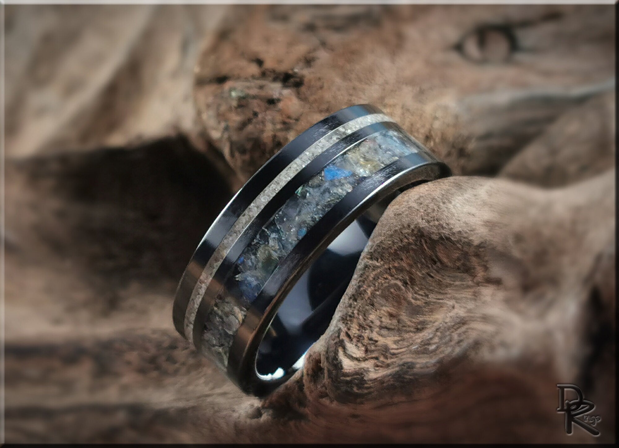 DR Rings black ceramic ring with dual inlays featuring a textured stone center and sleek polished edges