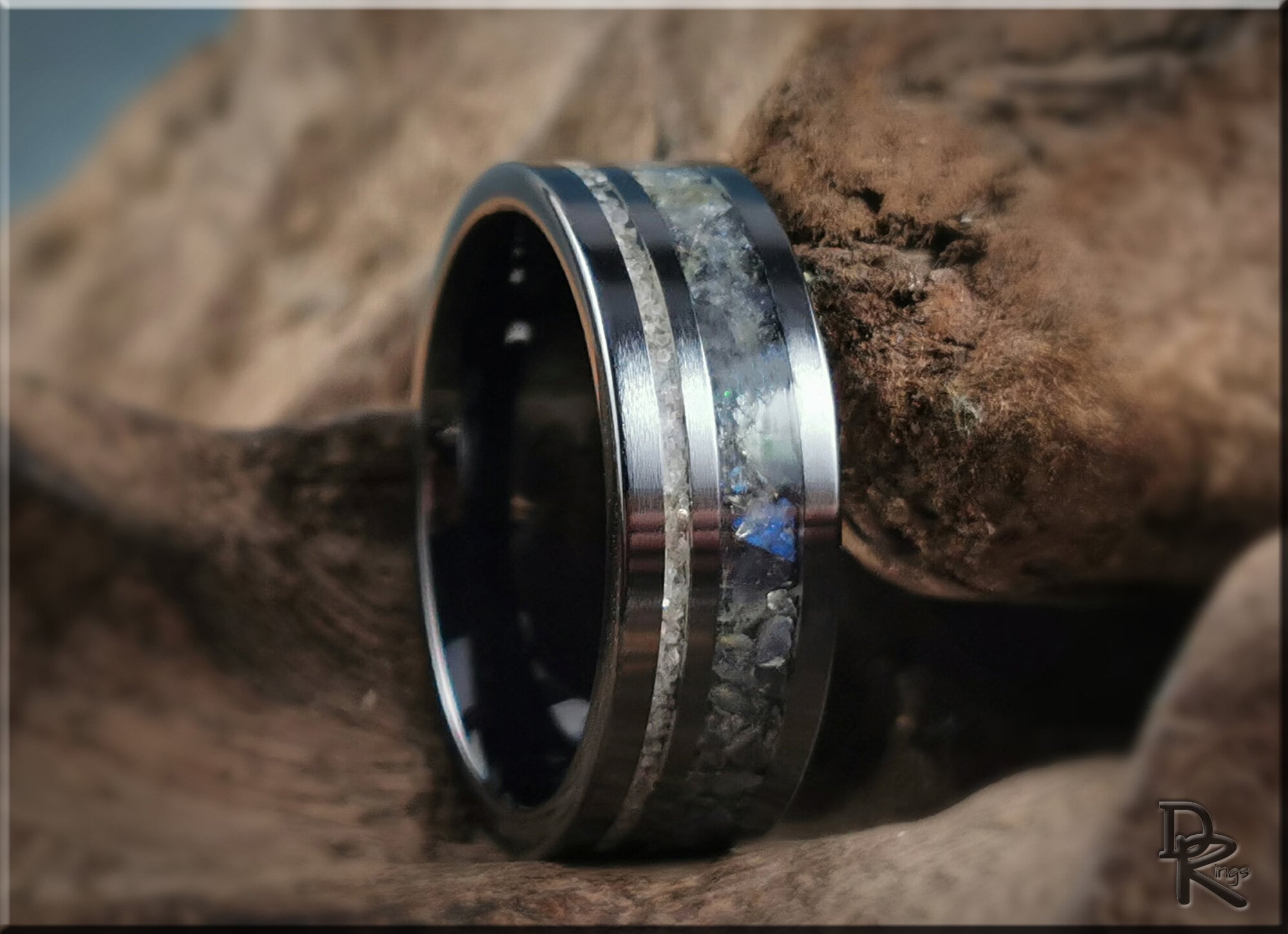 Black ceramic ring with dual inlays featuring metallic and stone textures by DR Rings