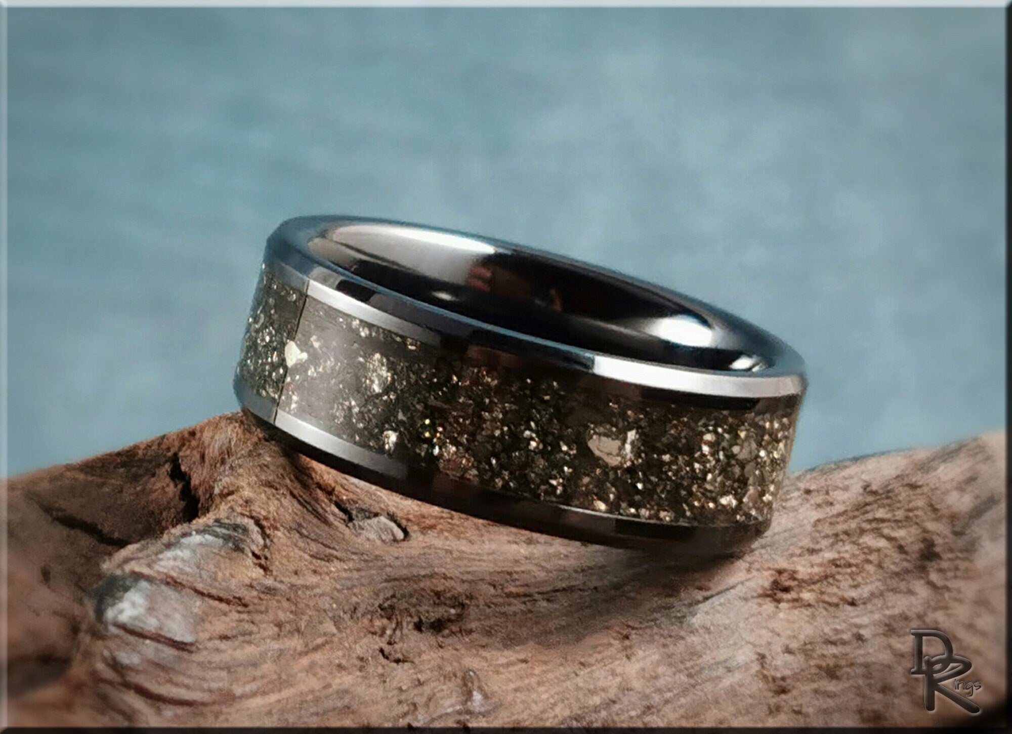 DR Rings ceramic ring with pyrite inlay featuring a polished dark finish on rustic wood background