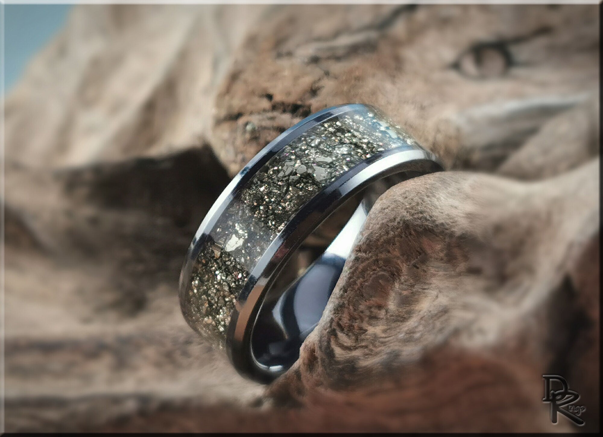 DR Rings ceramic ring with pyrite featuring a shiny metallic band and embedded sparkling pyrite stones