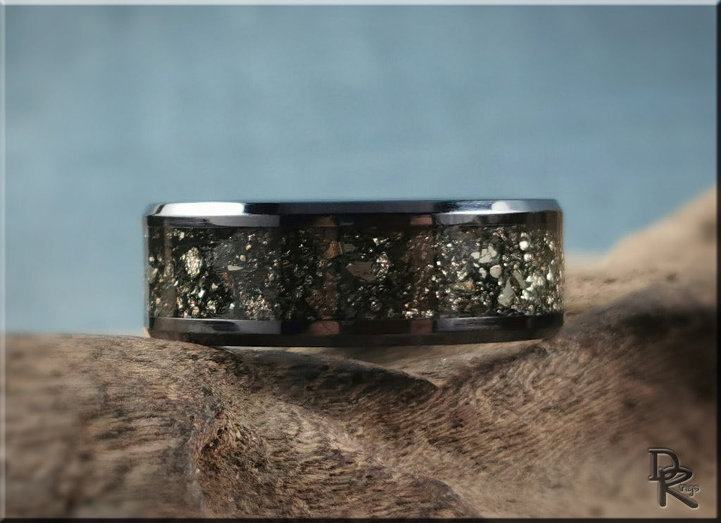 DR Rings ceramic ring with pyrite inlay on wooden surface with light blue background