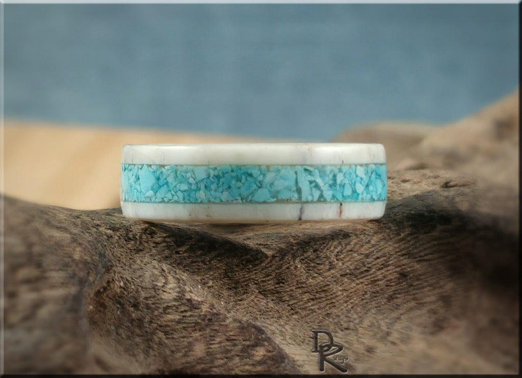 DR Rings deer antler ring with turquoise inlay on rustic wood background